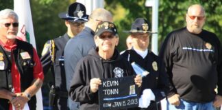 Ed Tonn, Kevin’s uncle, holds a plaque during the ceremony showing Kevin’s End of Watch date