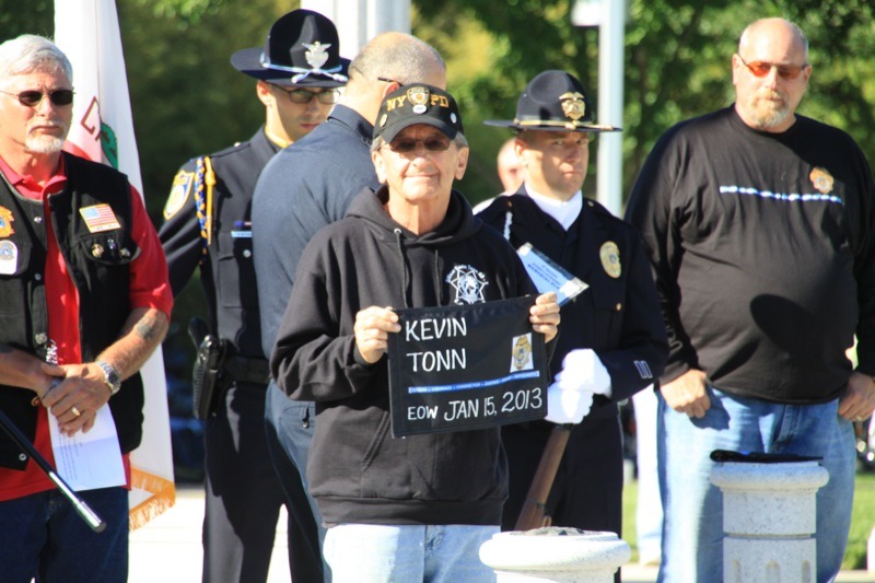Ed Tonn, Kevin’s uncle, holds a plaque during the ceremony showing Kevin’s End of Watch date