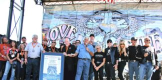 The Southern California Harley-Davidson Dealers Association presents Oliver Shokouh (far right) with a framed 30th anniversary Love Ride poster