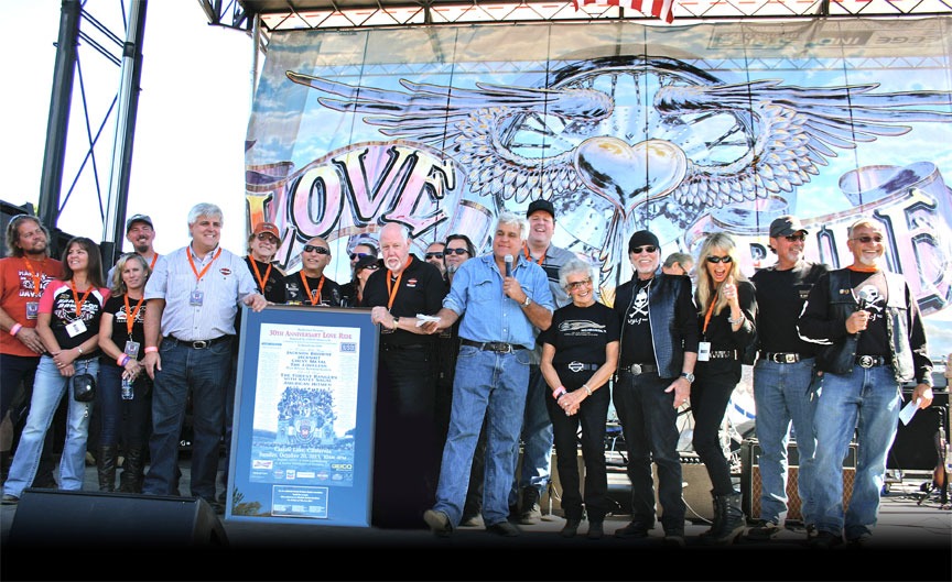 The Southern California Harley-Davidson Dealers Association presents Oliver Shokouh (far right) with a framed 30th anniversary Love Ride poster