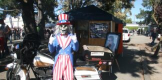 The Rip City Riders mascot poses with Chilly Billy's bike near the memorial display at the Petaluma Fairgrounds