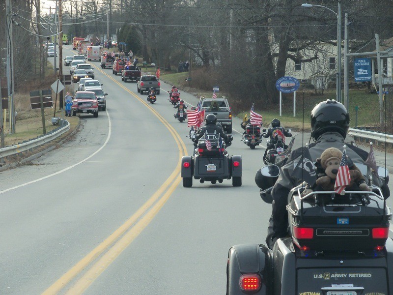 Patriot Guard Riders follow behind the firefighter escort en route to Arlington