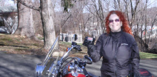 Shadow wearing the Firstgear women's Heated Jacket Liner, women's Heated Pants and holding the Remote Dual Heat Troller
