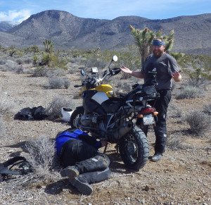 Field-testing the TCX X-Desert Boots while repairing a kickstand switch on the trail.