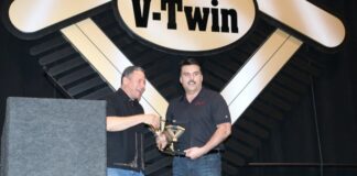 Polaris Industries' Steve Menneto accepts the Industry Leader of the Year award from emcee Griff Allen