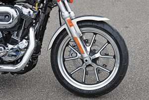 The SuperLow 1200T's black and silver, split five-spoke aluminum wheels carry Michelin Scorcher 11T touring tires.
