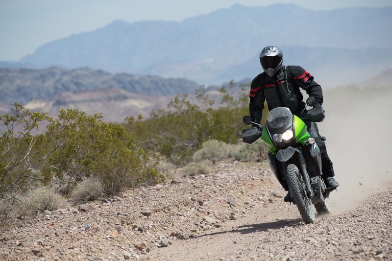 At a fast pace off-road, the KLR650 New Edition's stiffer suspension helps it handle much better.