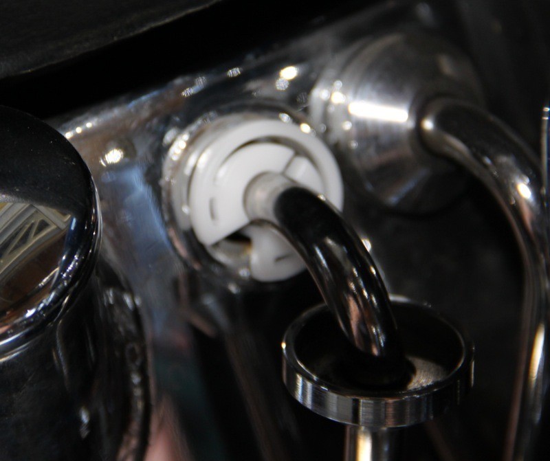 The plastic oil line extraction tool attaches to the oil return line, allowing the dirty oil to drip back into the bucket