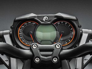 Symmetrical instrument panel has an LCD display flanked by analog gauges.