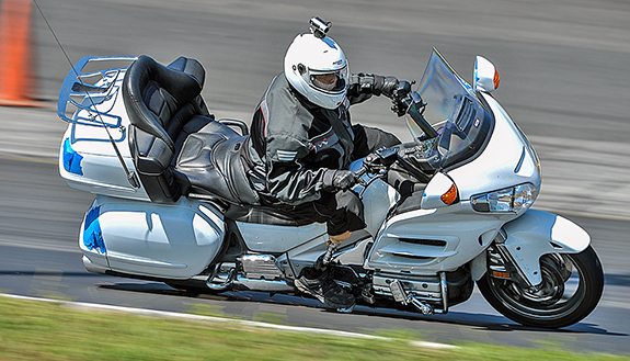 Several riders on luxury tourers carved up track-day curves.