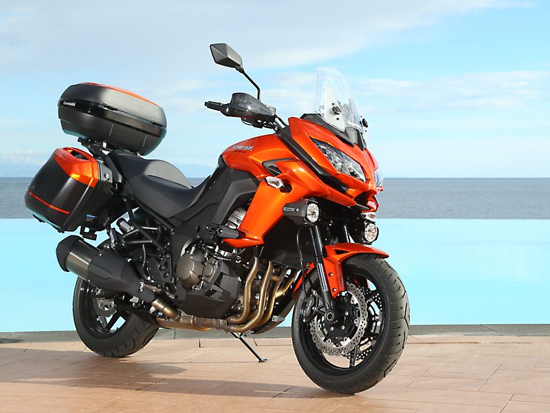 The 2015 Kawasaki Versys 1000 LT in Candy Burnt Orange/Metallic Spark Black with factory accessories.