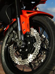 Up front, dual 4-piston calipers squeeze 310mm petal-style rotors. ABS is standard.