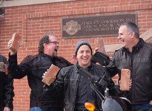 Participants celebrate after removing bricks from the front entrance of the Harley-Davidson headquarters in Milwaukee, Wisconsin. 