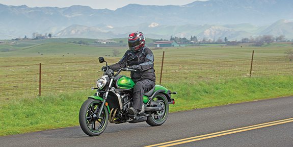 The cruiser setup with standard bar, standard seat and pegs mounted full forward. For longer travel with Kawasaki accessories, air flowed cleanly off the windscreen and the 14-liter bags feature nifty magnetic latches.