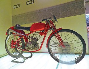 The first-ever Ducati racer, a 1948, 49cc buzz bomb using the original Cucciolo bicycle motor, is on display at the Ducati Museum. 