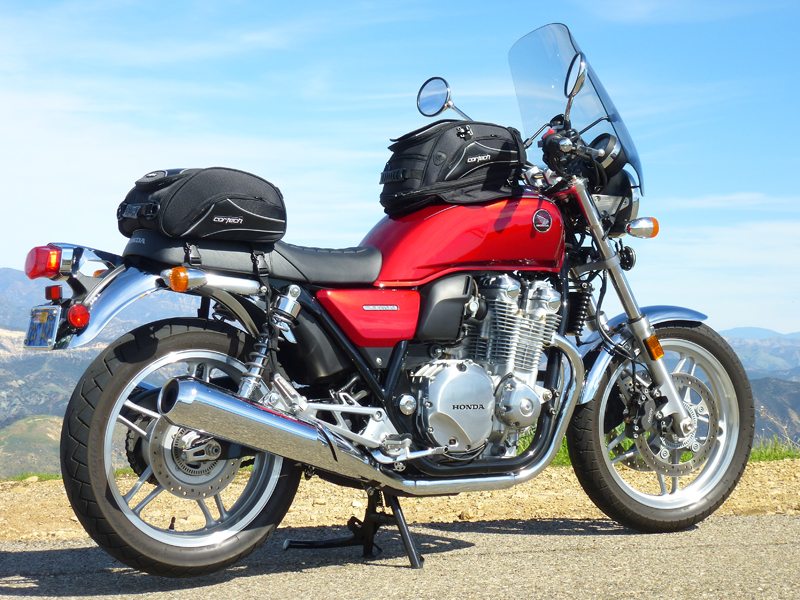 The 2014 Honda CB1100 Deluxe has more fuel capacity, a 6-speed transmission and Combined ABS.