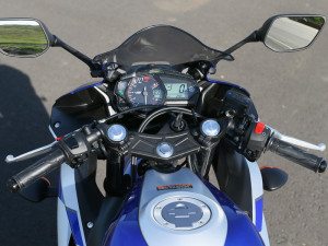 The YZF-R3's clip-on handlebars are above the triple clamp for a more relaxed riding position.