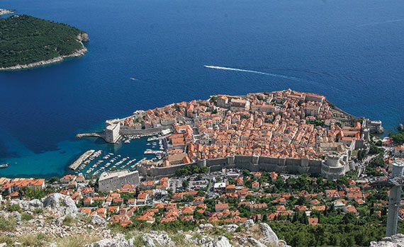 Looking down at the Old City of Dubrovnik, surrounded by the Adriatic Sea.