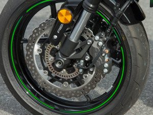 Up front, a pair of opposed 4-piston calipers squeeze petal-style rotors, and ABS is standard.