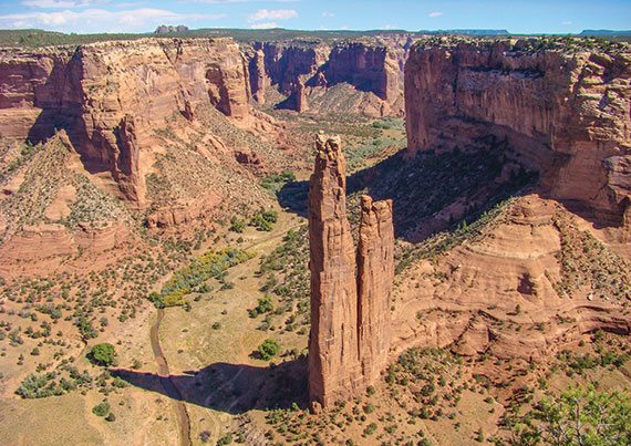 Spider Rock is an 800-foot sandstone spire rising from the Canyon de Chelly floor.