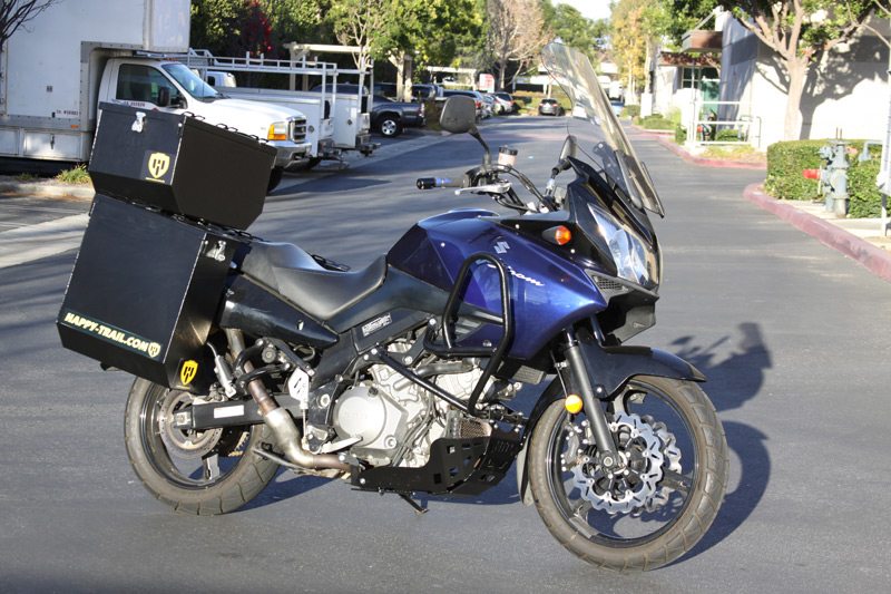 Our 2005 Suzuki V-Strom 1000 project bike is complete, with Happy Trails panniers, top box, engine guards and skid plate.