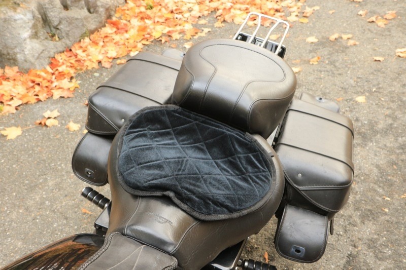 The Butt Buffer can be placed narrow edge forward to fit the shape of the seat (left photo), or it can be placed wide edge forward to provide some padding for the thighs. Note that the photo on the right, with the wide edge forward, also illustrates the included strap-and-clip system to fasten the cushion to the seat.