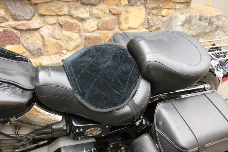 The Butt Buffer can be placed narrow edge forward to fit the shape of the seat (left photo), or it can be placed wide edge forward to provide some padding for the thighs. Note that the photo on the right, with the wide edge forward, also illustrates the included strap-and-clip system to fasten the cushion to the seat.