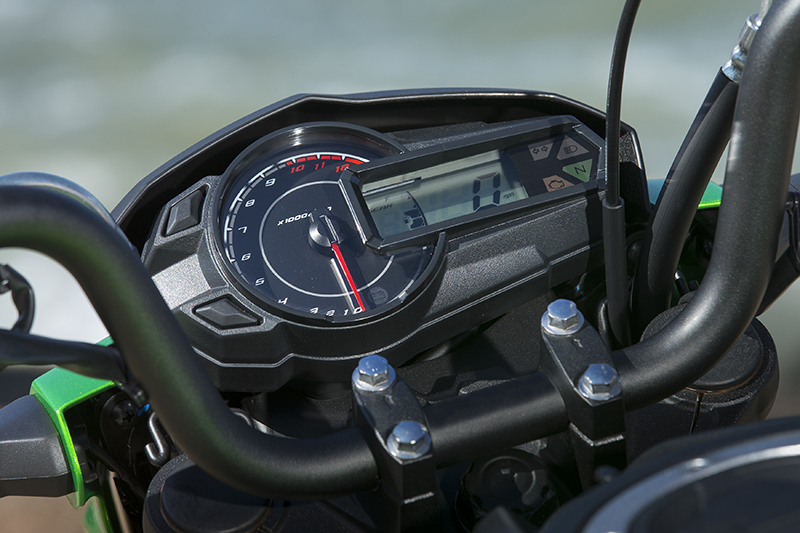A snazzy instrument cluster includes an analog tachometer, digital speed and gear indicator, and fuel gauge.