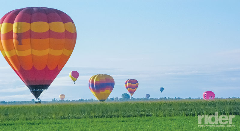 Hot air balloons landing in the fields one summer morning.