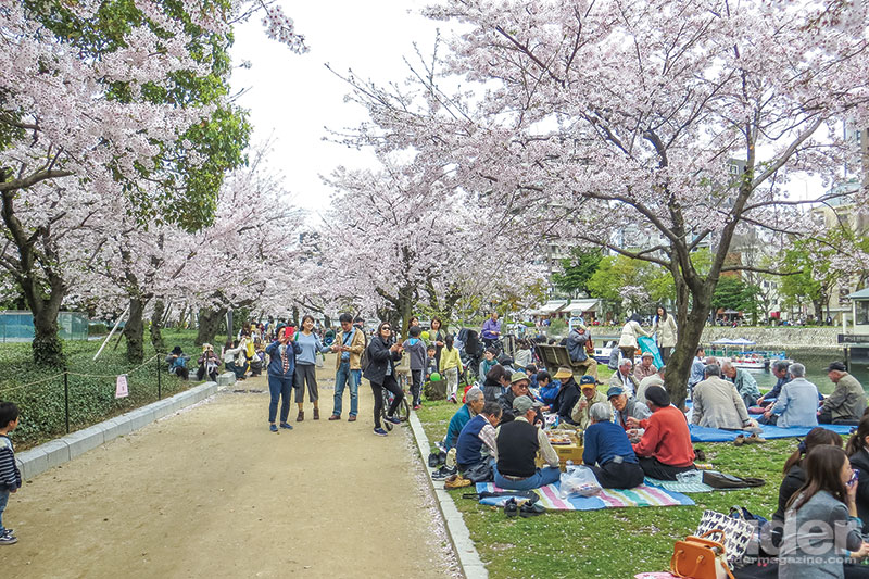 Above: Picnicking under the glorious cherry blossoms in Hiroshima Peace Memorial Park. Below: The Genbaku Dome was the only building left standing after the atomic bomb wiped out the city in August 1945. It has been preserved in Hiroshima Peace Memorial Park as a stark reminder of the horror.