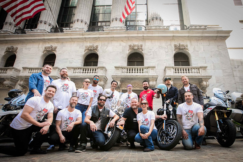The celebrity riders for Kiehl's 7th Annual LifeRide pose in front of the New York Stock Exchange, August 3, 2016. (Photo: Jean-Francois Musy)