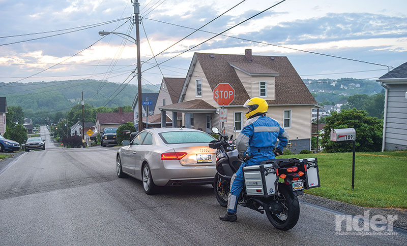 This rider has left no room for escape, is in physical and mental neutral and is highly vulnerable to that distracted driver approaching from behind.