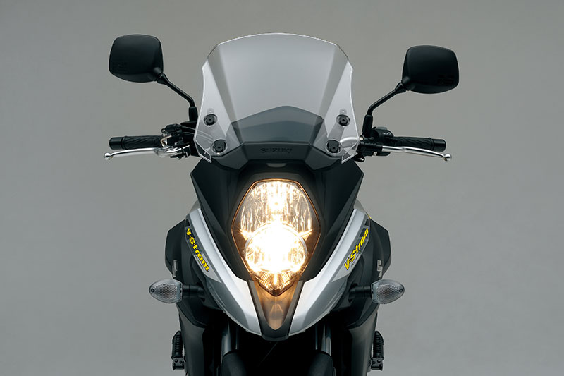 The new V-Strom 650 now looks more like its DL1000 big brother, with a prominent beak, vertically stacked headlight and manually adjustable windscreen.