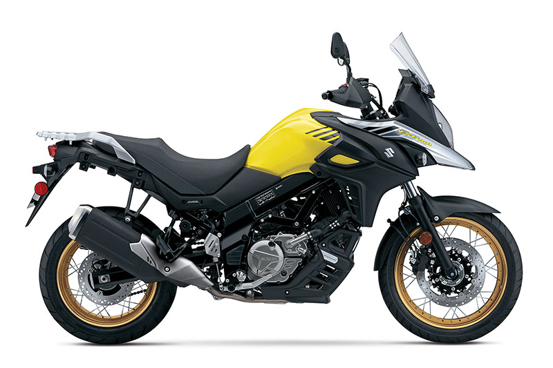 The 2017 Suzuki V-Strom 650XT features spoked wheels with tubeless tires, hand guards and an engine cowl. Bikes in the Champion Yellow No. 2 paint scheme get special gold wheels.