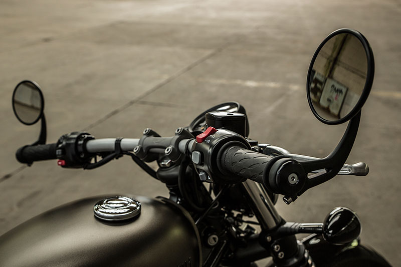 The Bonneville Bobber has a wide, flat handlebar with bar-end mirrors. The twin gauges are adjustable to match the riding position.