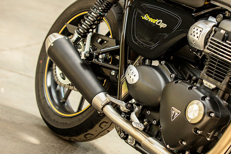 Triumph's Street Cup has a blacked-out drivetrain and unique stubby silencers.