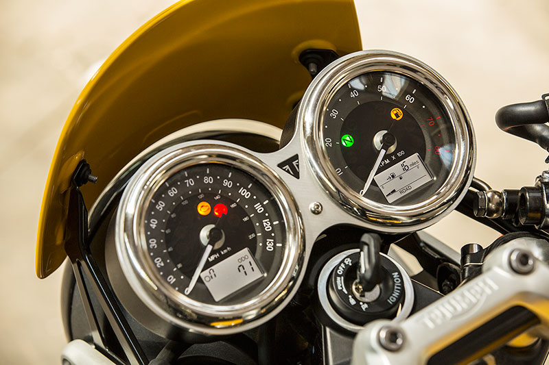 The Triumph Street Cup's twin gauges have polished stainless steel bezels like the Thruxton.