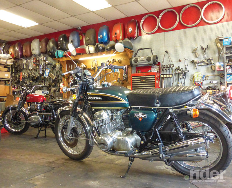 The Honda’s Freedom Green Metallic paint pops against the shop’s backdrop of classic bikes, tanks and tools. When they’re running well, 1970s Hondas still make great daily riders.