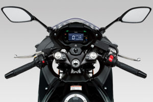 Behind the Suzuki GSX250R's small windscreen is a reverse-lit LCD instrument panel.