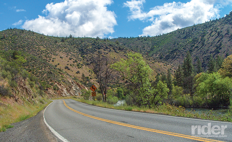 The eastern end of the State of Jefferson Scenic Byway is in very dry country near Yreka, California, with some cottonwoods near the river, sunburnt grass and sage-covered hillsides.