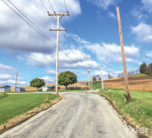 In reality, the road veers left while the telephone lines shoot off on a different path. 