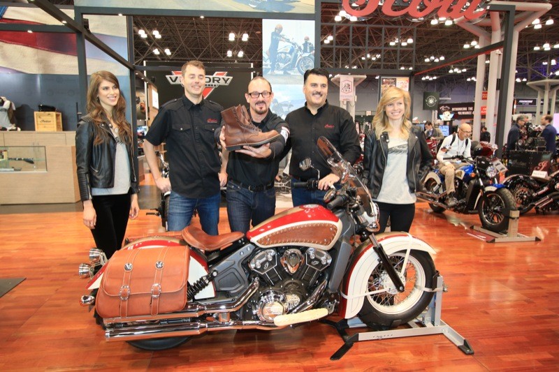 Brian Klock (center), Polaris President of Motorcycles Steve Menneto (2nd from right), and Indian employees display the Red Wing Scout that Klock customized