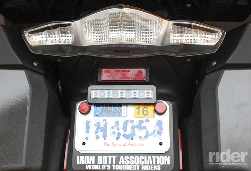The standard version is a full-perimeter license plate frame. The Jr. version (pictured) keeps more of the license plate surface exposed and doesn’t cover a license plate backer.
