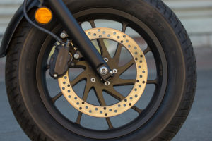 In a nice touch, the Rebel's front brake disc carrier is cut to match the cast wheel's spokes, for a clean look.