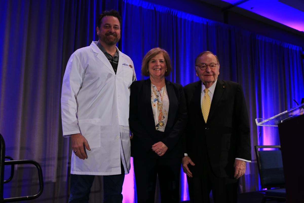 Harley-Davidson Director of Government Affairs Ed Moreland trades in his leather jacket for a symbolic white lab coat, a special award to recognize Harley-Davidson’s fundraising efforts for the Muscular Dystrophy Association’s research program. The Harley-Davidson family has raised more than $103 million over 38 years to advance treatments and cures for neuromuscular diseases. MDA President and CEO Lynn Vos and MDA Chairman of the Board R. Rodney Howell, M.D., presented the award.