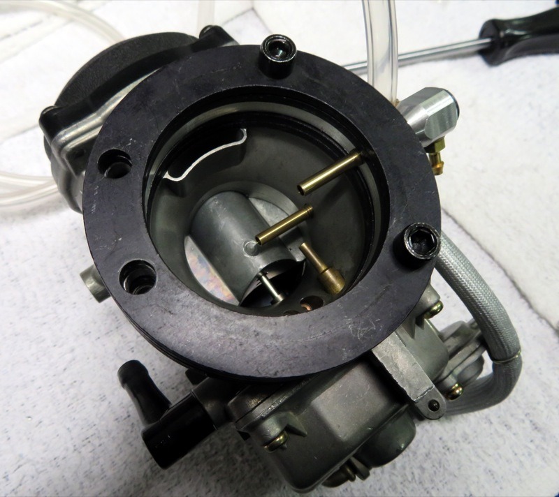 Here’s a photo of a “lab rat” CV with two Intelajets installed, one in the body of the carb, the other in the adaptor bolted to the intake. You wouldn’t (shouldn’t!) want both (at least not like this) but it gives you a sense of the installation options.