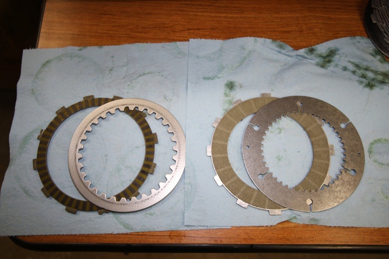 The stock assist-and-slip clutch (l.) has nine friction plates and eight steel plates while the Bandit Sportsman Superclutch (r.) features 11 friction plates and 10 steel plates that are slightly thinner and have more surface area than the stock plates