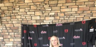 Faith, on her Indian Chieftain Dark Horse, is posing for pictures before she meets all the fans that showed up to the event