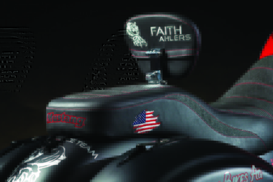 Mustang Seats made a custom heated seat for Faith which brings her closer to the handlebars. The seat also has an adjustable back rest, custom “gripper” cover material and quality custom embroidery.