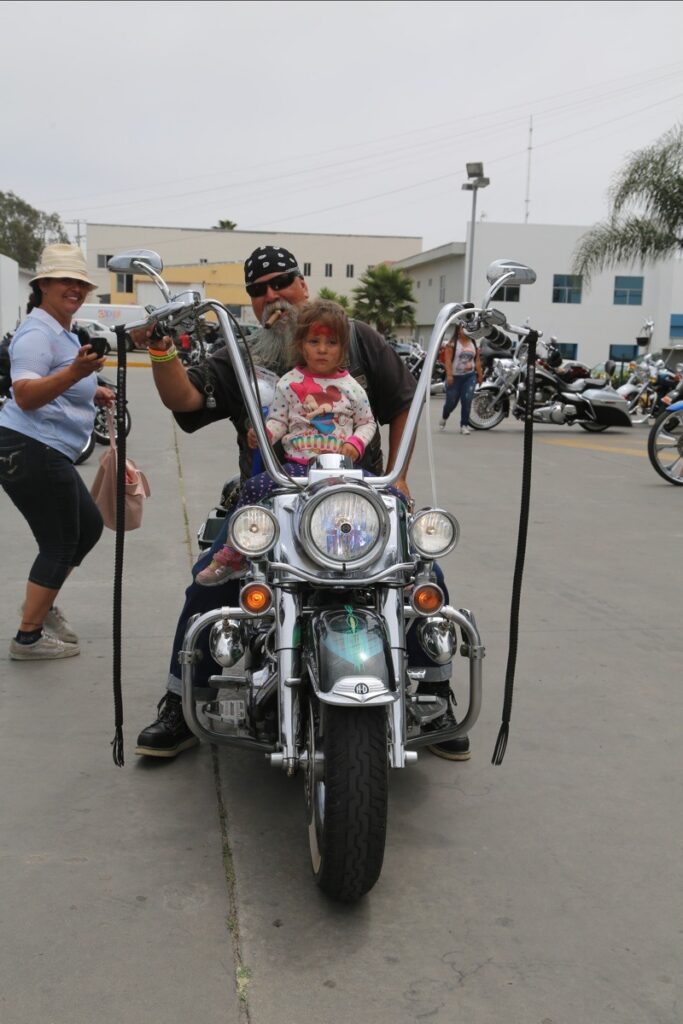 Pio Hollywood Hernandez gave this girl and her mother (left) the thrill of their lives. A future biker is born.